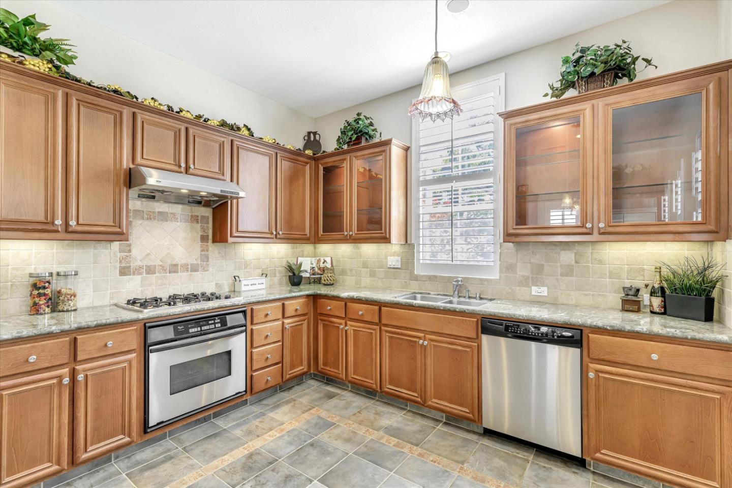 2124 Harvest Moon Lane San Ramon, CA 94582 - Photo 7 of 31 a kitchen with stainless steel appliances granite countertop a sink stove and cabinets