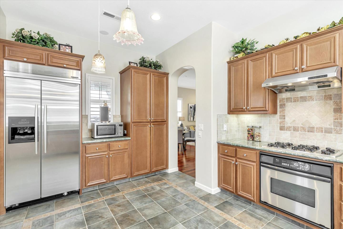 2124 Harvest Moon Lane San Ramon, CA 94582 - Photo 10 of 31 a kitchen with stainless steel appliances granite countertop a refrigerator a sink and white cabinets