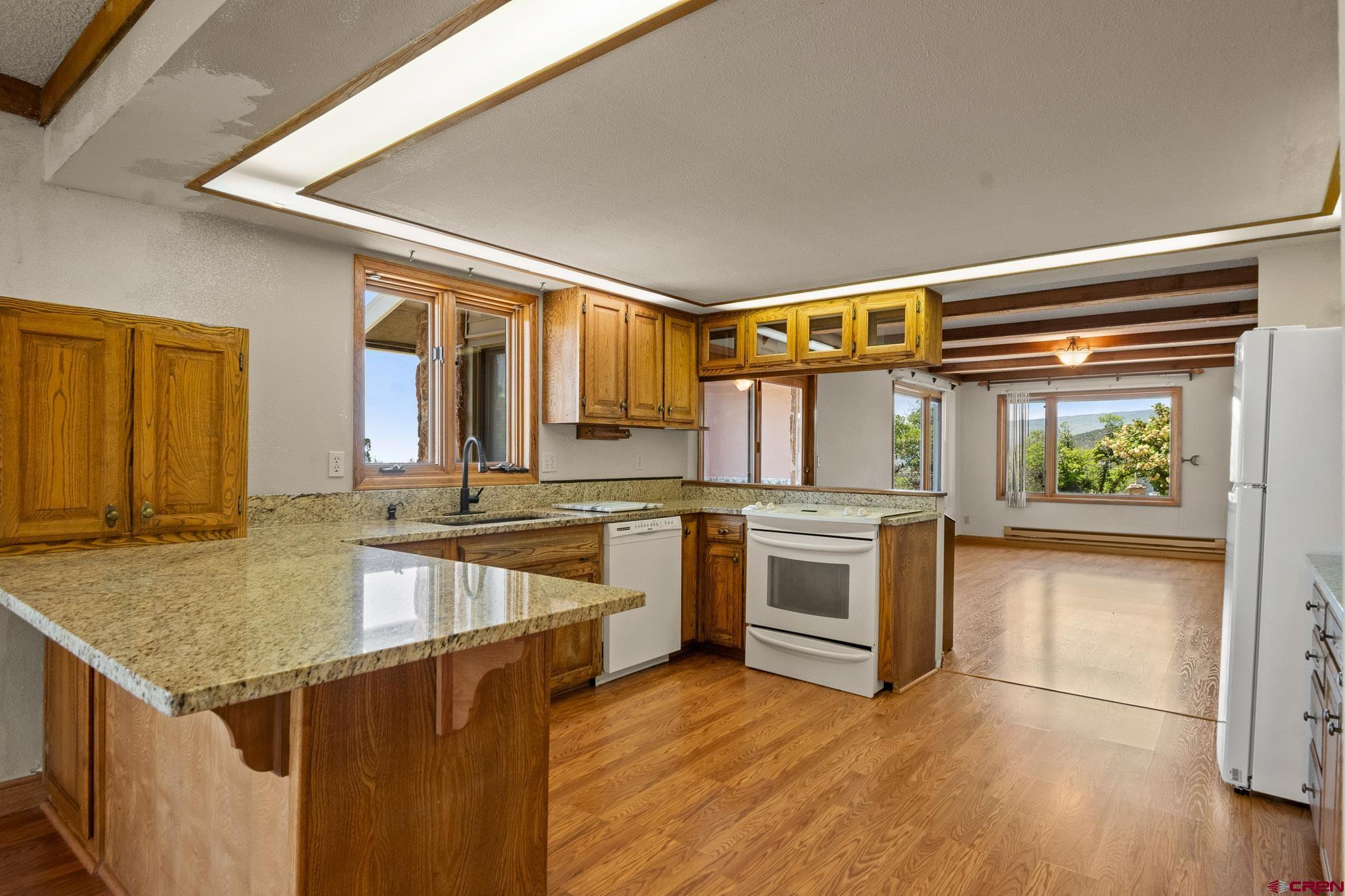 21565 Highway 65 Cedaredge, CO 81413 - Photo 11 of 42 a kitchen with a stove a sink and a refrigerator