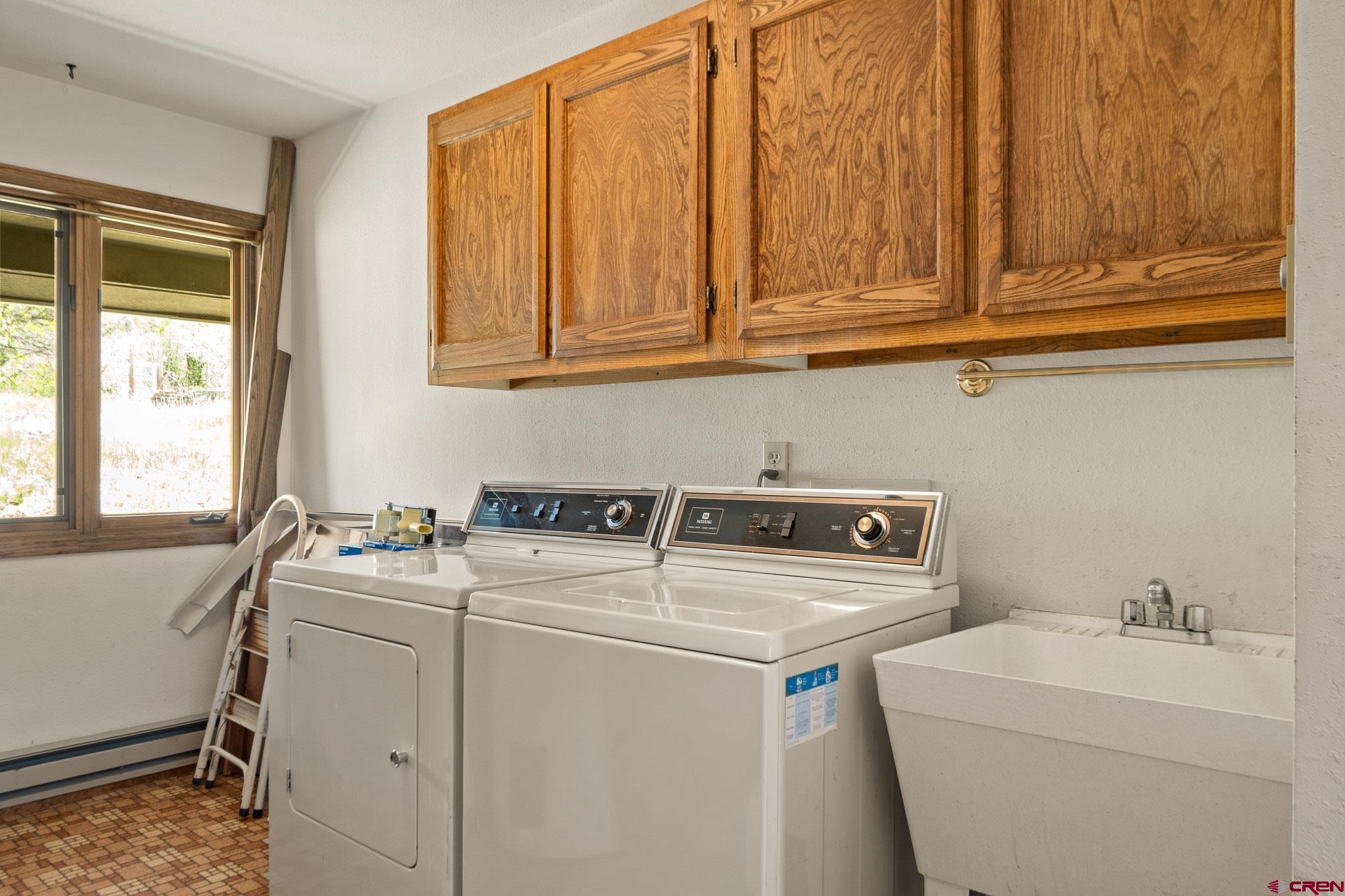 21565 Highway 65 Cedaredge, CO 81413 - Photo 17 of 42 a utility room with dryer and washer