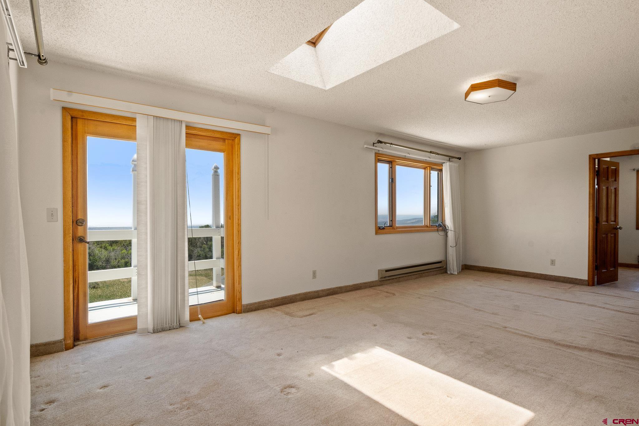 21565 Highway 65 Cedaredge, CO 81413 - Photo 20 of 42 an empty room with windows and closet