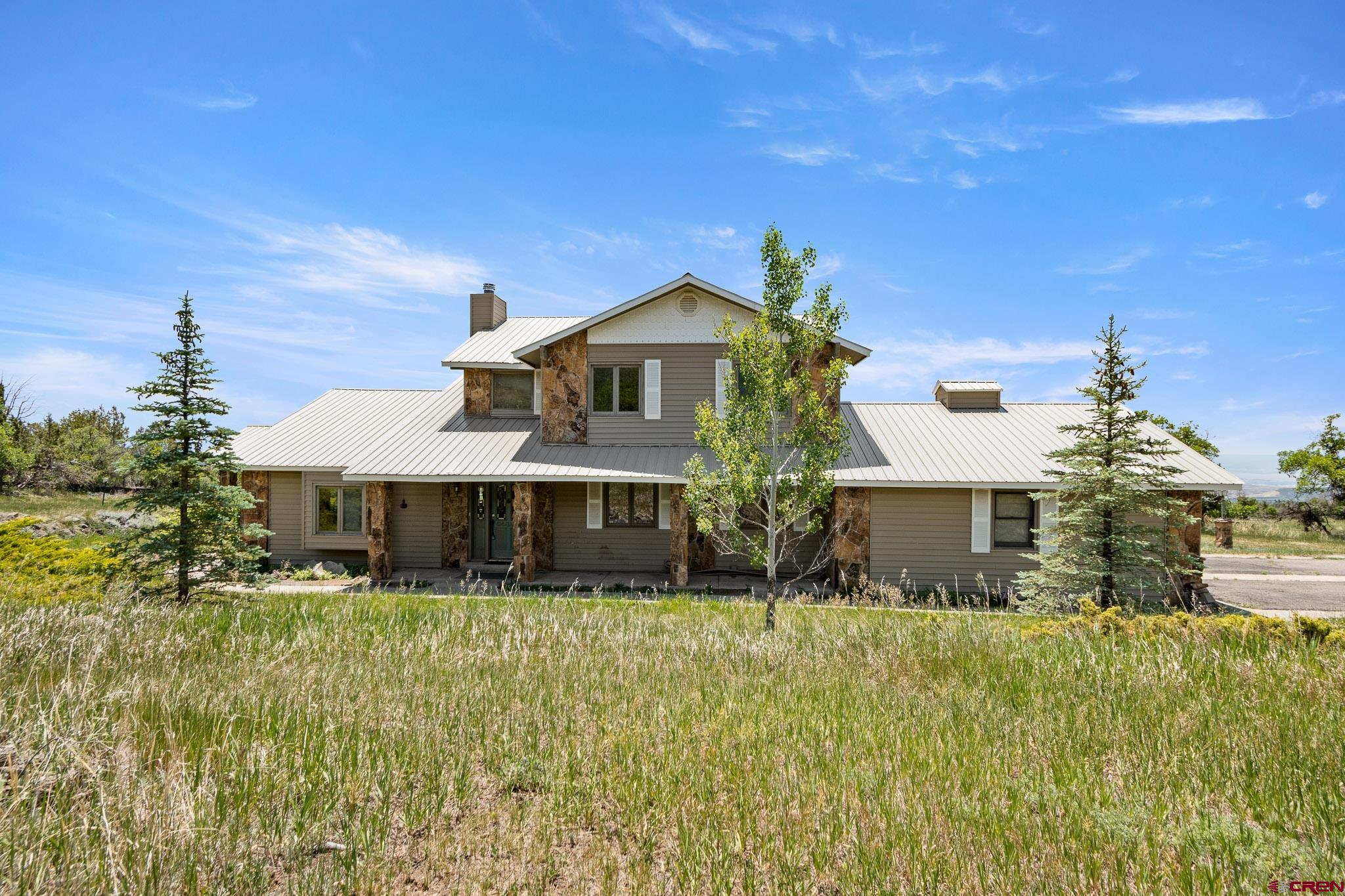 21565 Highway 65 Cedaredge, CO 81413 - Photo 2 of 42 a front view of a house with a yard