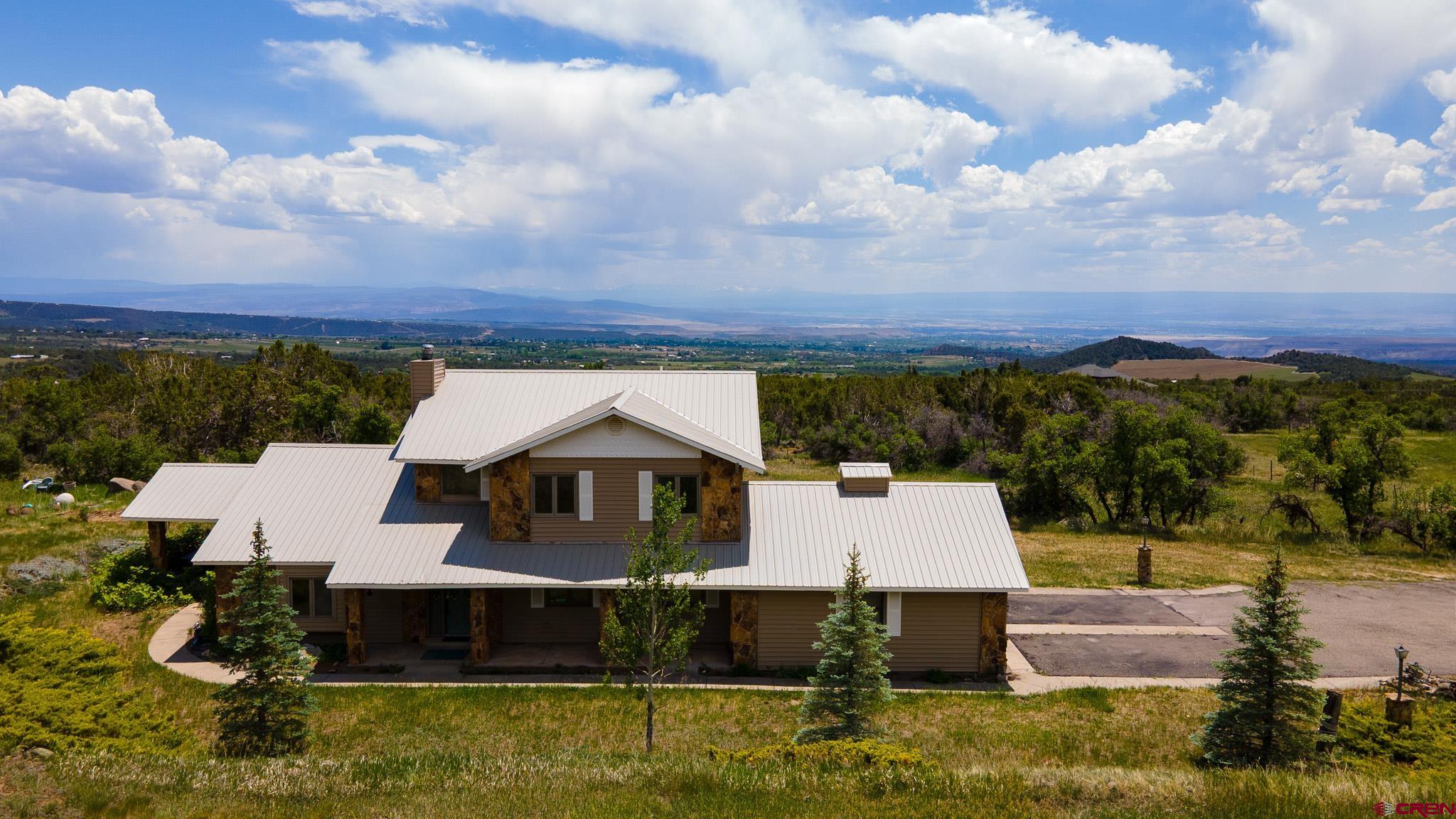 21565 Highway 65 Cedaredge, CO 81413 - Photo 29 of 42 a front view of a house with a yard