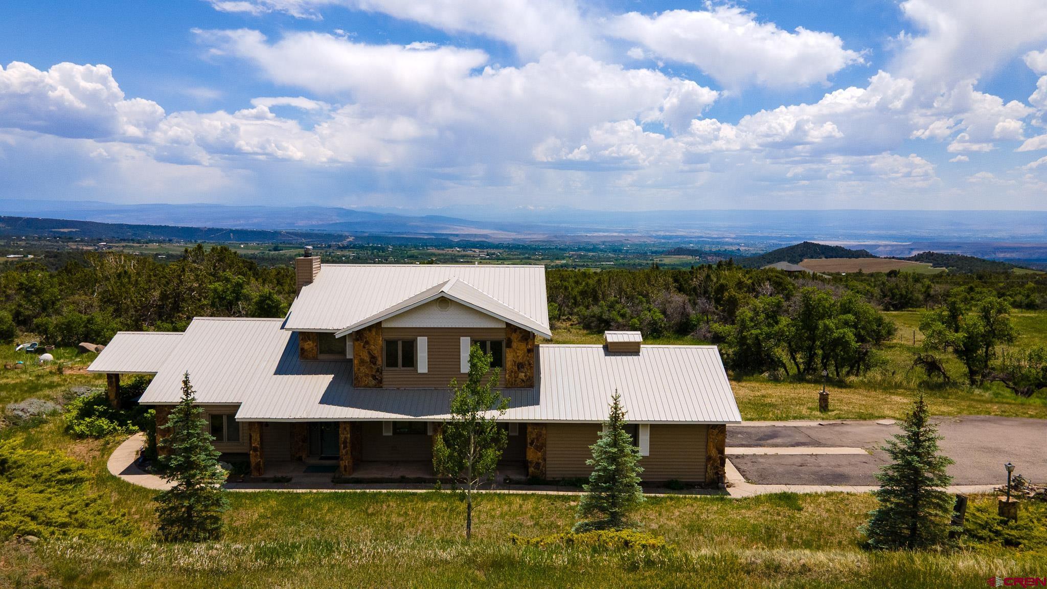 21565 Highway 65 Cedaredge, CO 81413 - Photo 30 of 42 a front view of a house with a yard