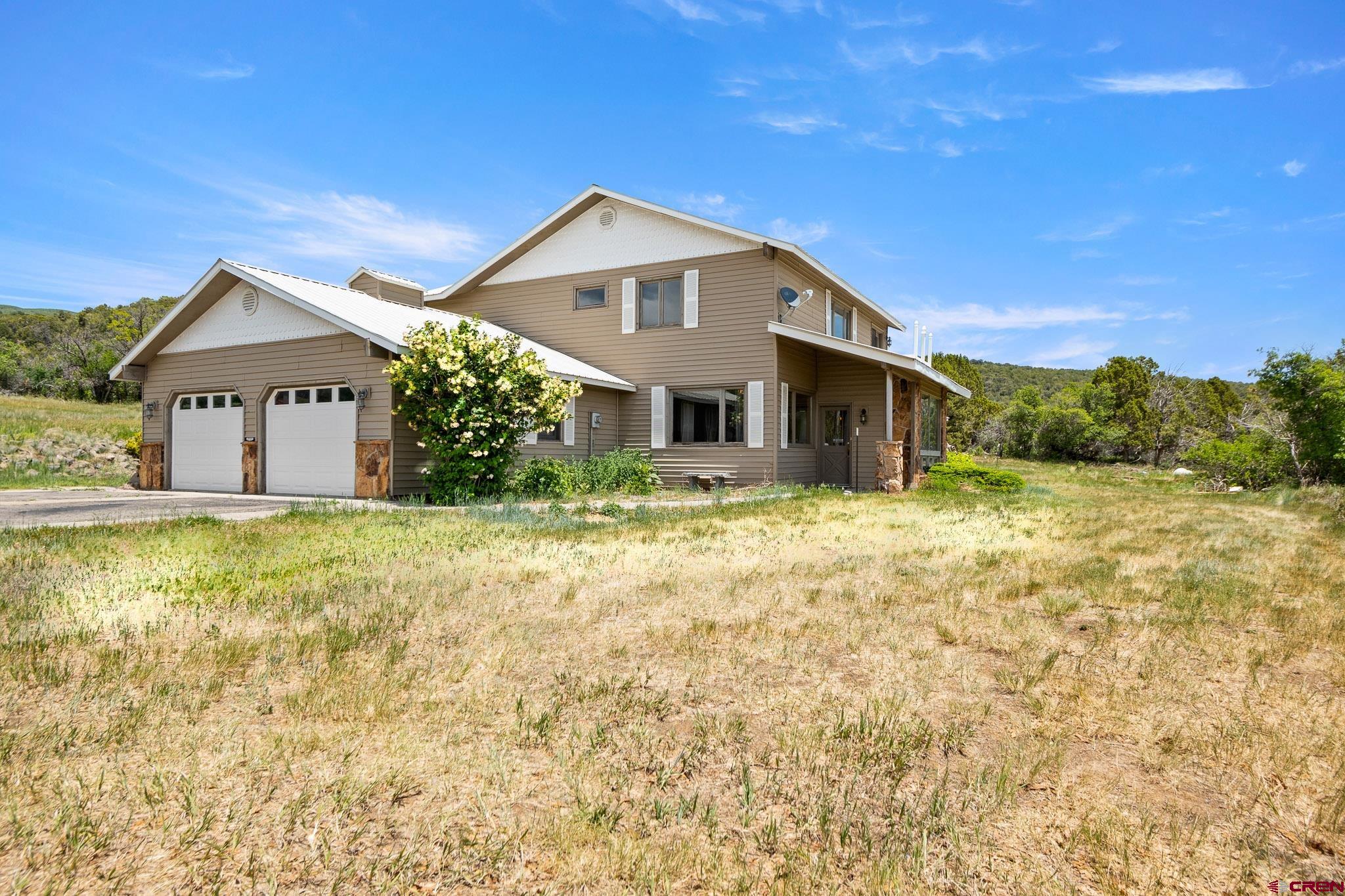21565 Highway 65 Cedaredge, CO 81413 - Photo 32 of 42 a front view of a house with a yard