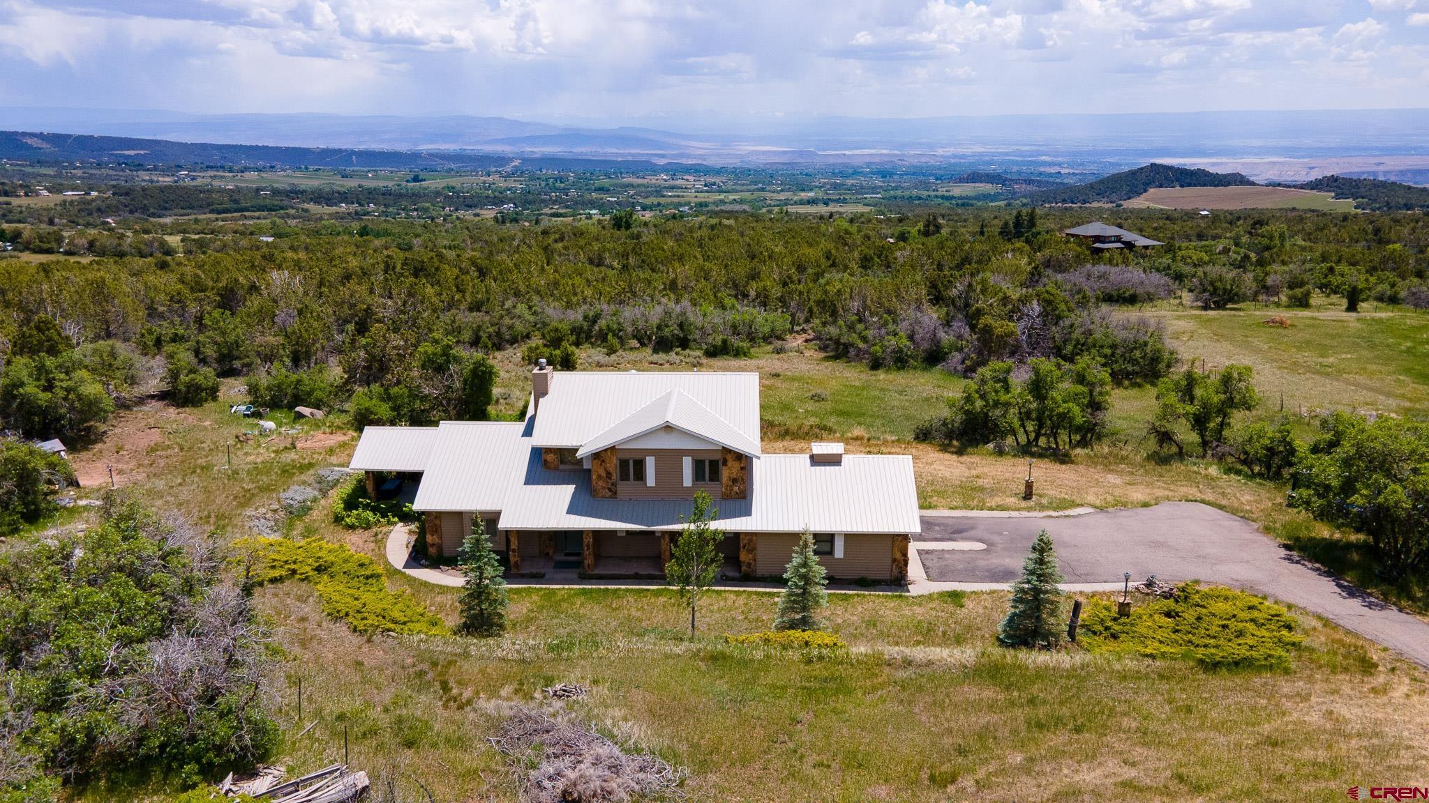 21565 Highway 65 Cedaredge, CO 81413 - Photo 35 of 42 an aerial view of a house with a garden and lake view