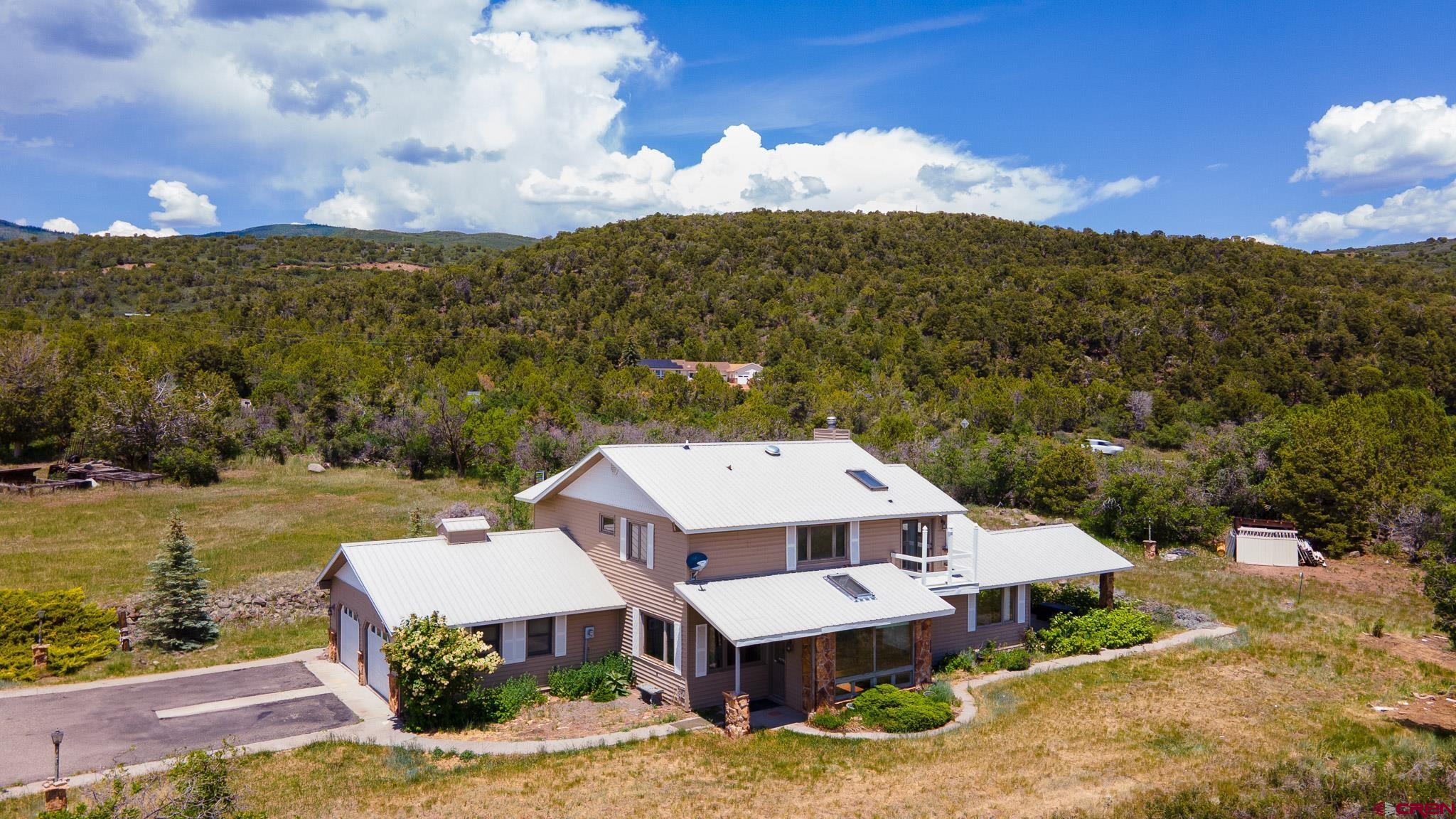 21565 Highway 65 Cedaredge, CO 81413 - Photo 36 of 42 a view of a house with a yard