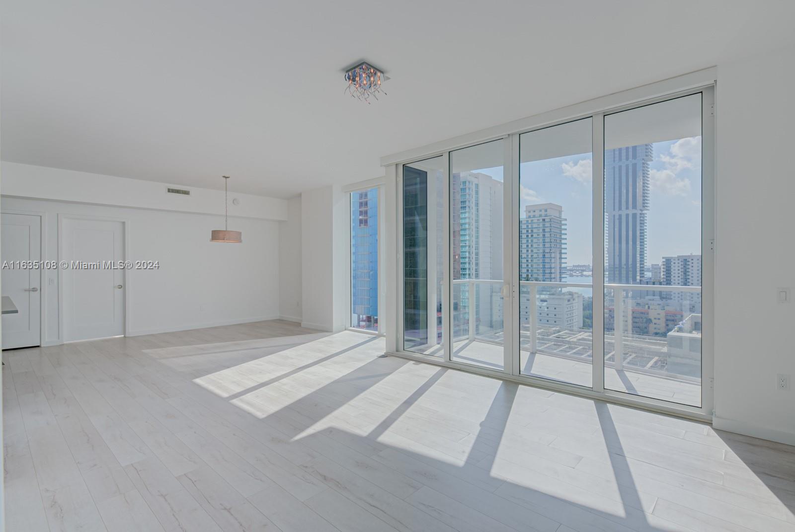601 Northeast 27th Street, Unit 1502 Miami, FL 33137 - Photo 23 of 61 a view of an empty room with glass door