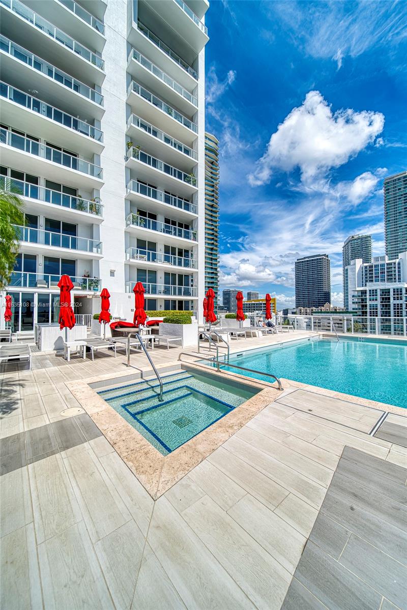 601 Northeast 27th Street, Unit 1502 Miami, FL 33137 - Photo 41 of 61 a multi story building with retail shops and traffic signal