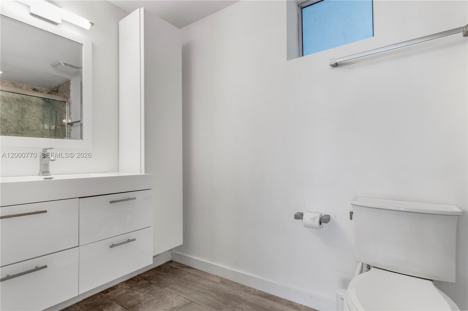 3339 Virginia Street, Unit 339 Miami, FL 33133 - Photo 13 of 24 a bathroom with a sink a toilet and vanity