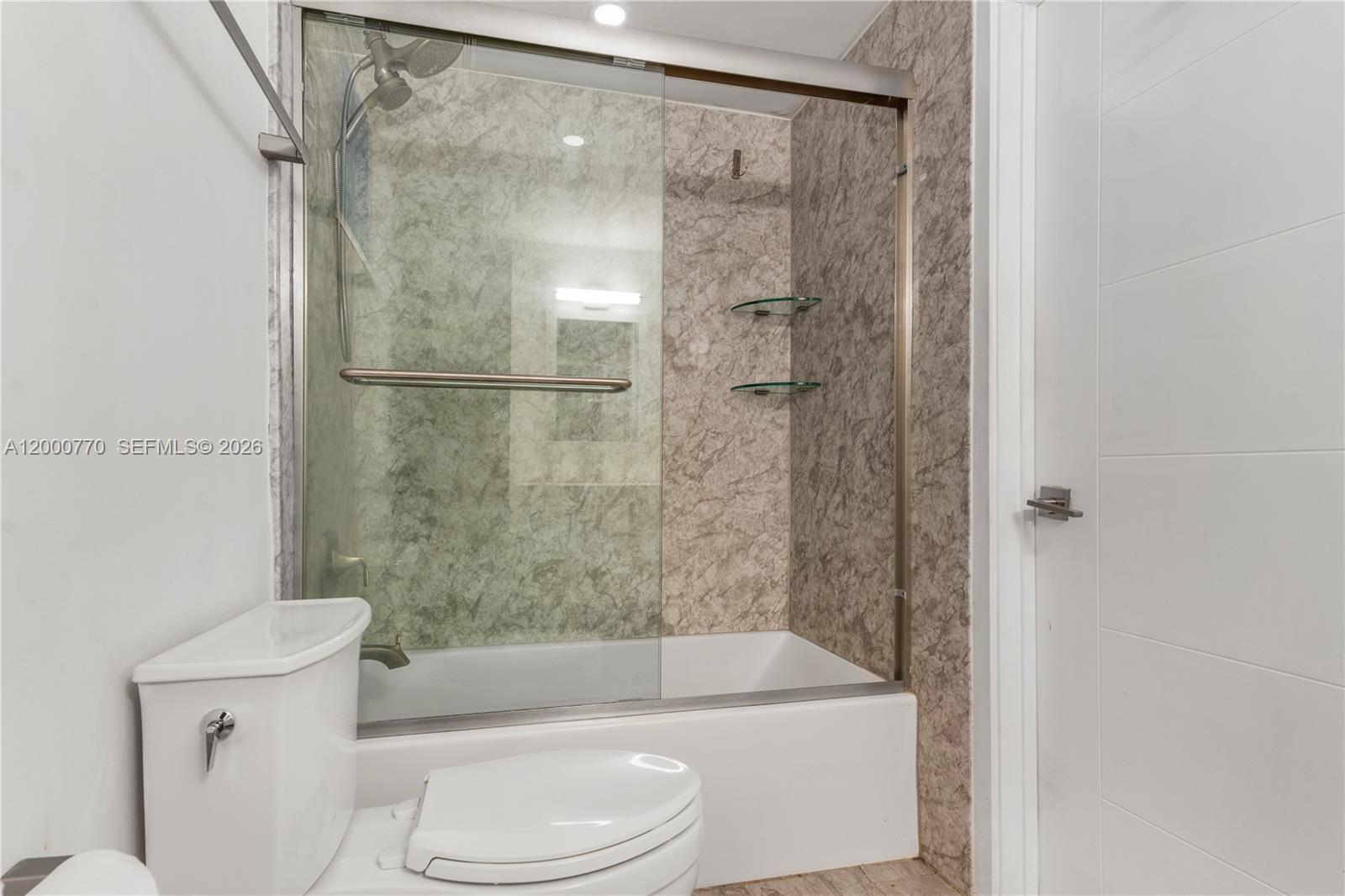 3339 Virginia Street, Unit 339 Miami, FL 33133 - Photo 16 of 24 a bathroom with a toilet and a bathtub