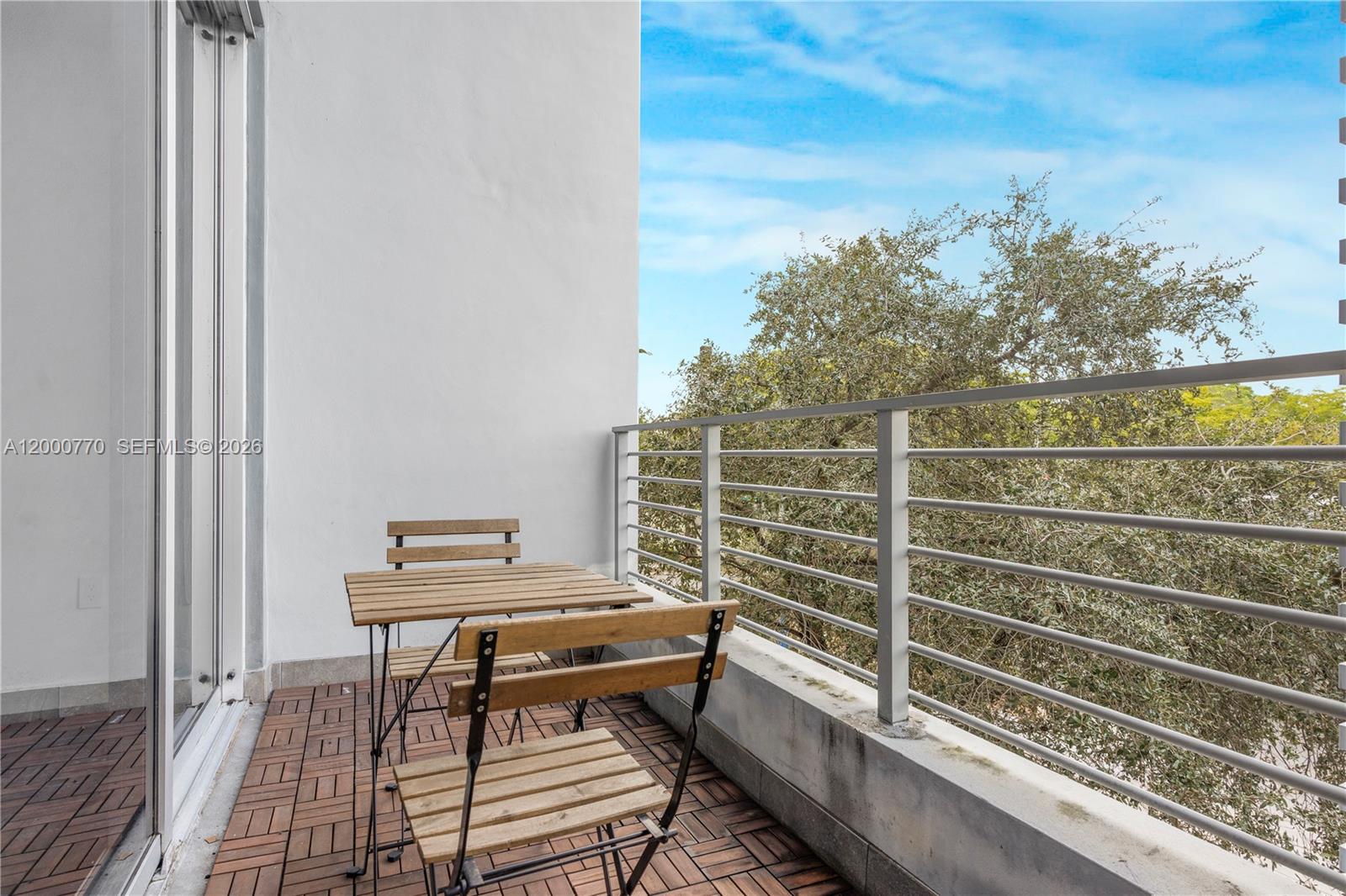 3339 Virginia Street, Unit 339 Miami, FL 33133 - Photo 18 of 24 a view of a balcony with two chairs and a table