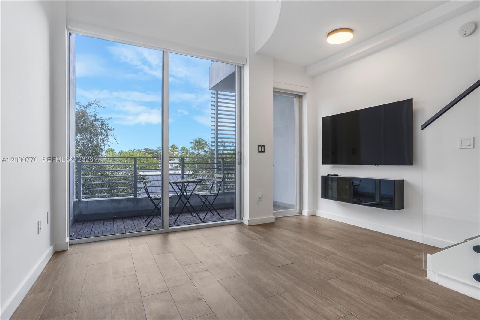 3339 Virginia Street, Unit 339 Miami, FL 33133 - Photo 2 of 24 a view of a livingroom with furniture and a flat screen tv