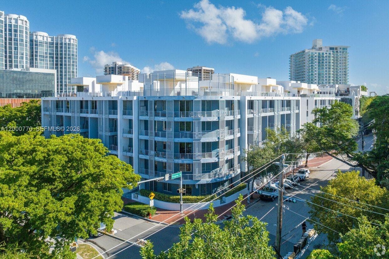 3339 Virginia Street, Unit 339 Miami, FL 33133 - Photo 23 of 24 a large building with a lot of plants in front of it