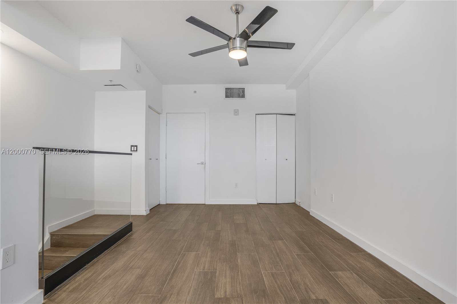 3339 Virginia Street, Unit 339 Miami, FL 33133 - Photo 9 of 24 a view of empty room with wooden floor and fan