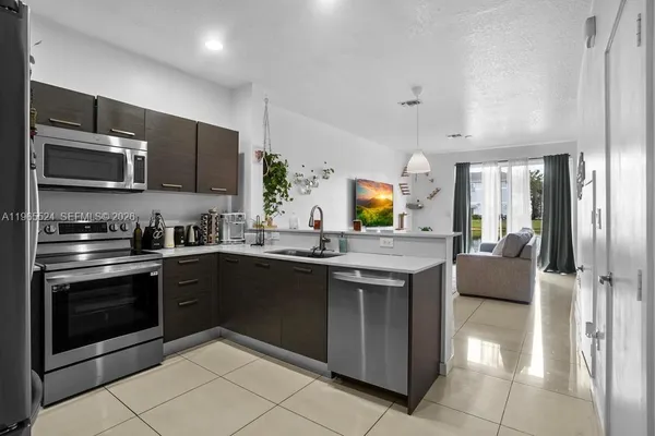 a kitchen with stainless steel appliances granite countertop a stove and a sink