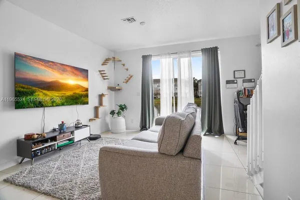 a living room with furniture and a flat screen tv