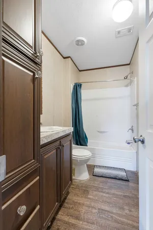 a bathroom with a toilet a sink and shower