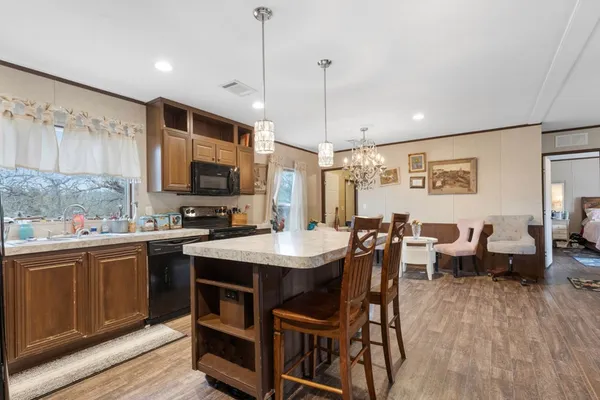 a large kitchen with a table and chairs