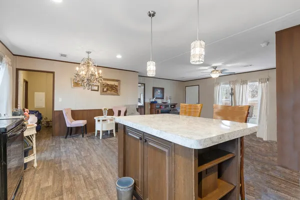 a large kitchen with a table and chairs