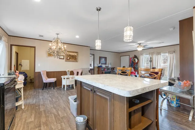 a large kitchen with a table and chairs