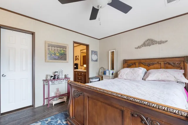 a bedroom with a large bed and a window