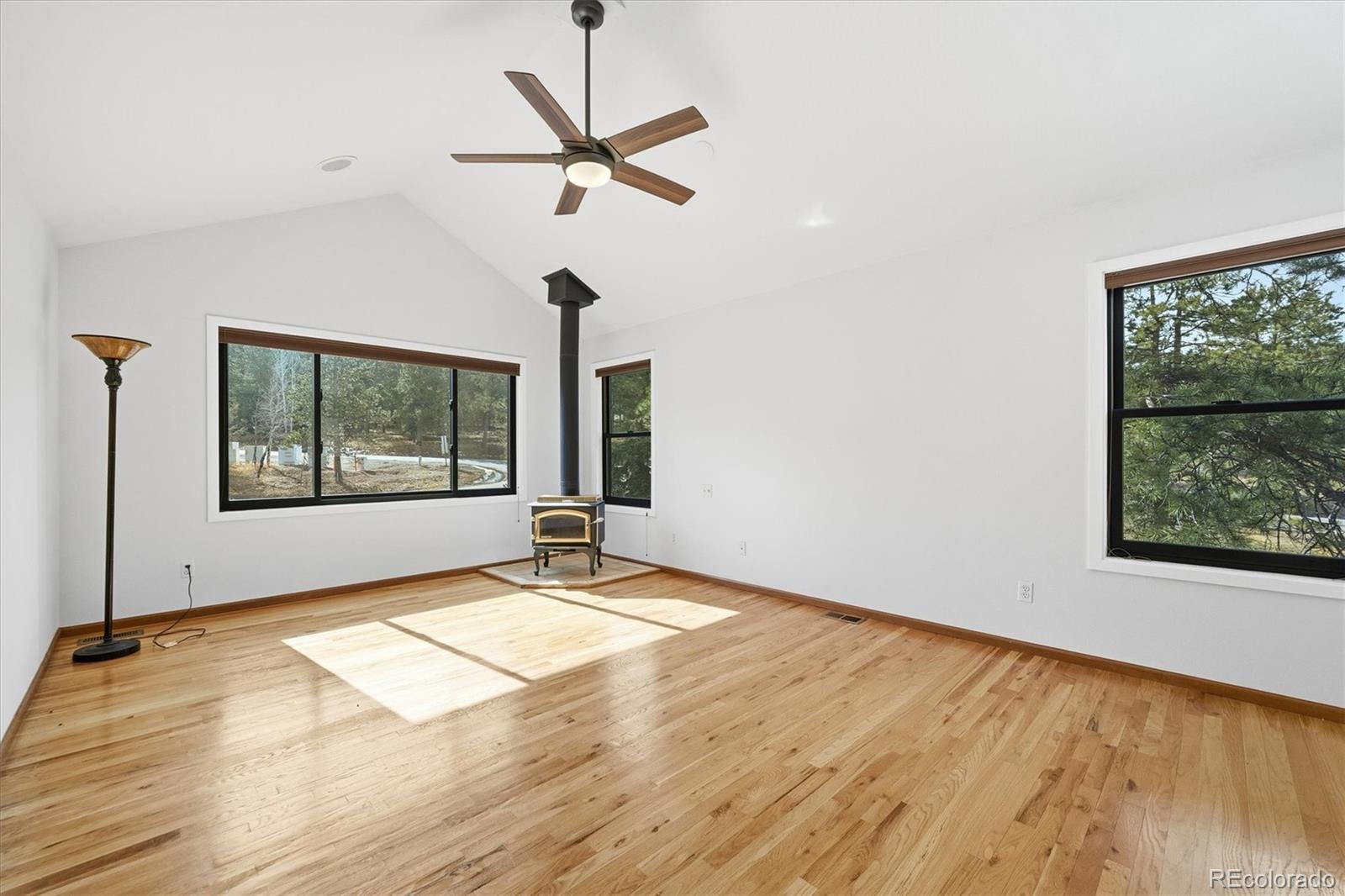 2565 Nova Road Pine, CO 80470 - Photo 19 of 50 a view of an empty room with a window and wooden floor
