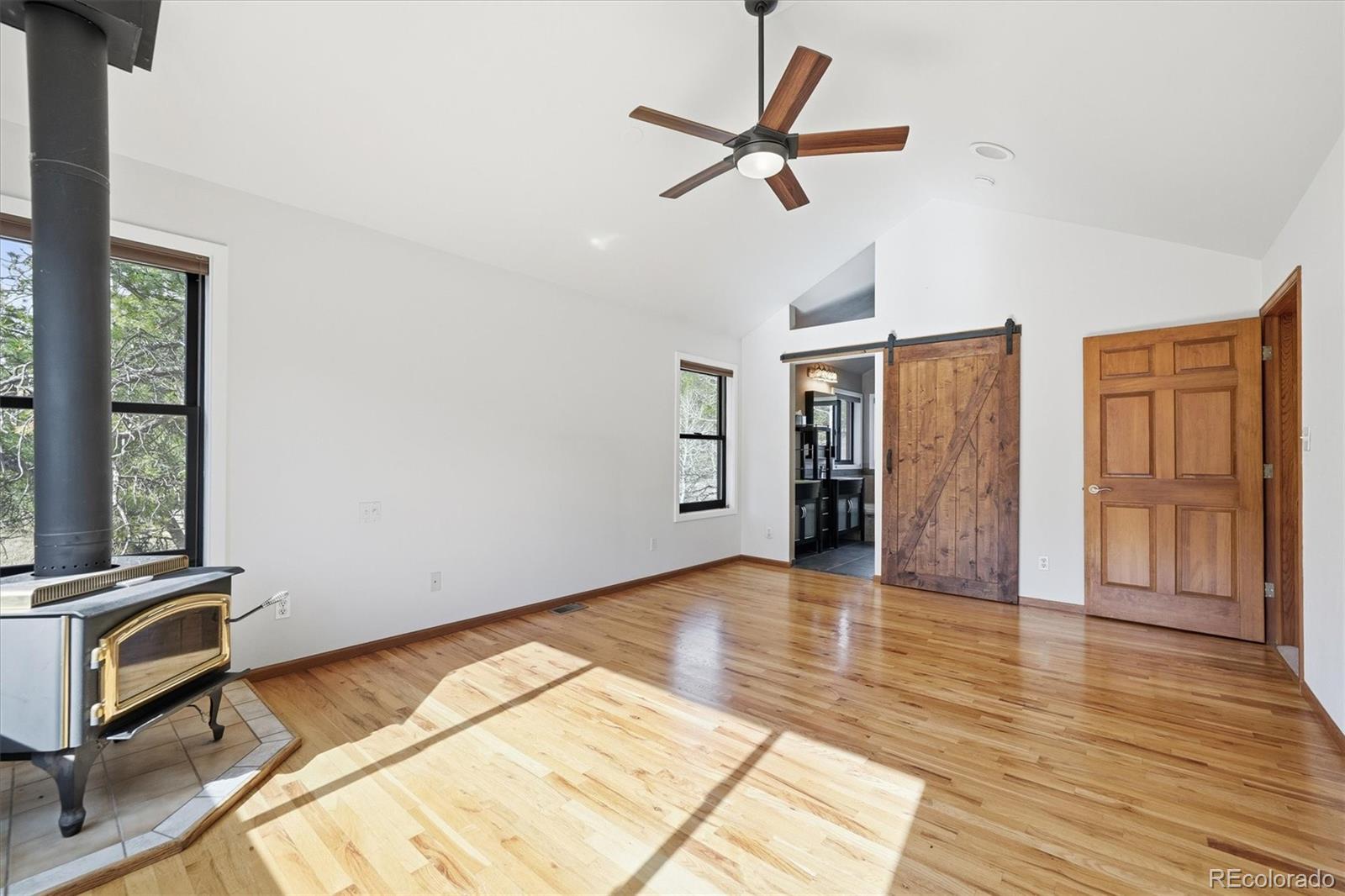 2565 Nova Road Pine, CO 80470 - Photo 20 of 50 a view of a livingroom with wooden floor and a ceiling fan