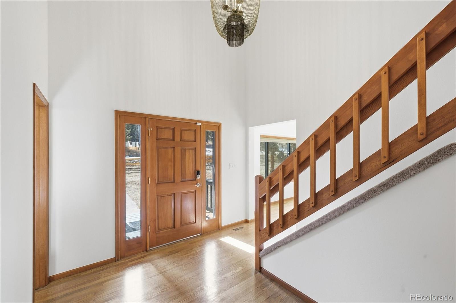 2565 Nova Road Pine, CO 80470 - Photo 2 of 50 a view of an entryway with wooden floor