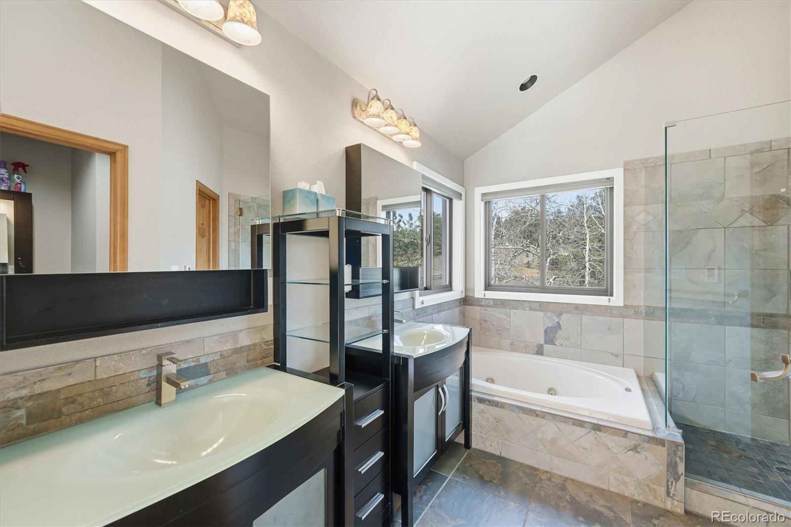 2565 Nova Road Pine, CO 80470 - Photo 21 of 50 a bathroom with a bathtub sink and mirror