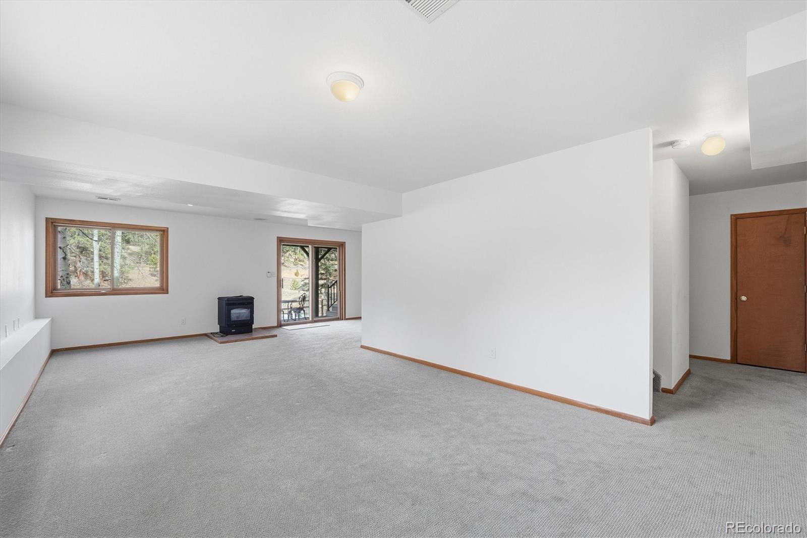 2565 Nova Road Pine, CO 80470 - Photo 30 of 50 an empty room with windows and cabinet