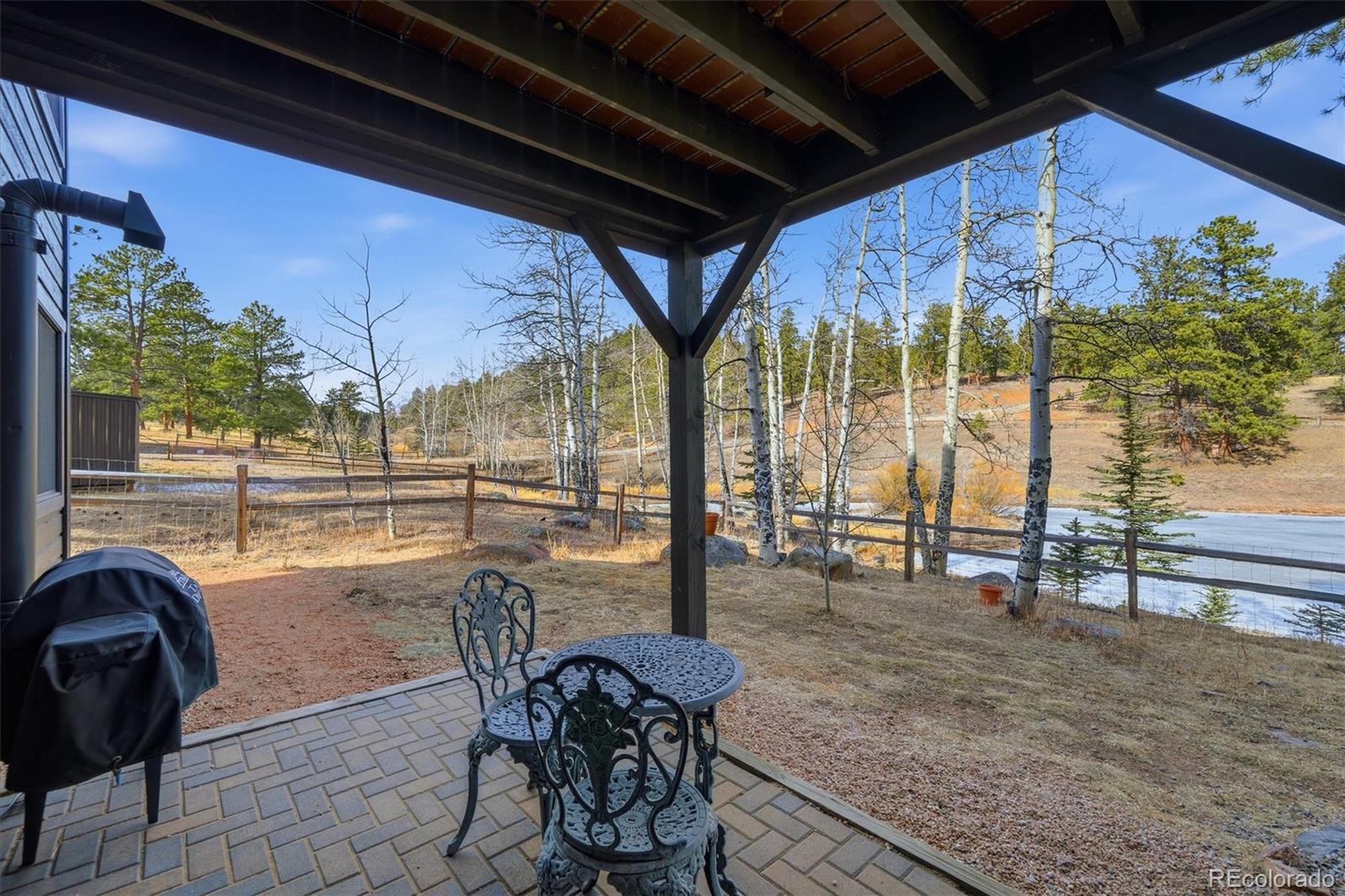 2565 Nova Road Pine, CO 80470 - Photo 32 of 50 a view of a porch with furniture and yard