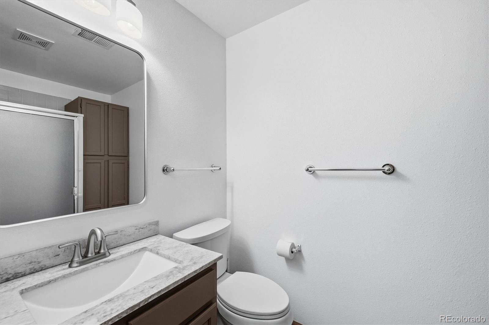 2565 Nova Road Pine, CO 80470 - Photo 33 of 50 a bathroom with a granite countertop sink toilet and mirror