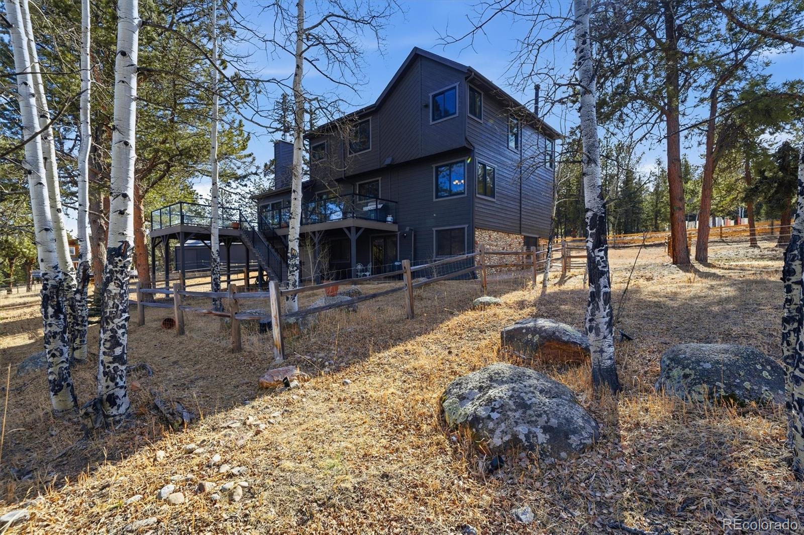 2565 Nova Road Pine, CO 80470 - Photo 42 of 50 a view of a house with a yard covered in snow
