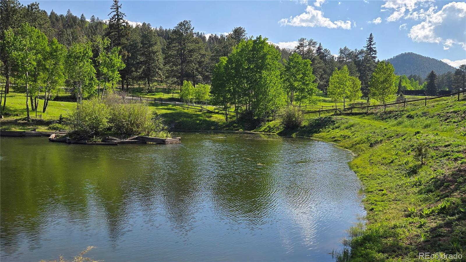 2565 Nova Road Pine, CO 80470 - Photo 45 of 50 a view of a lake with houses in background