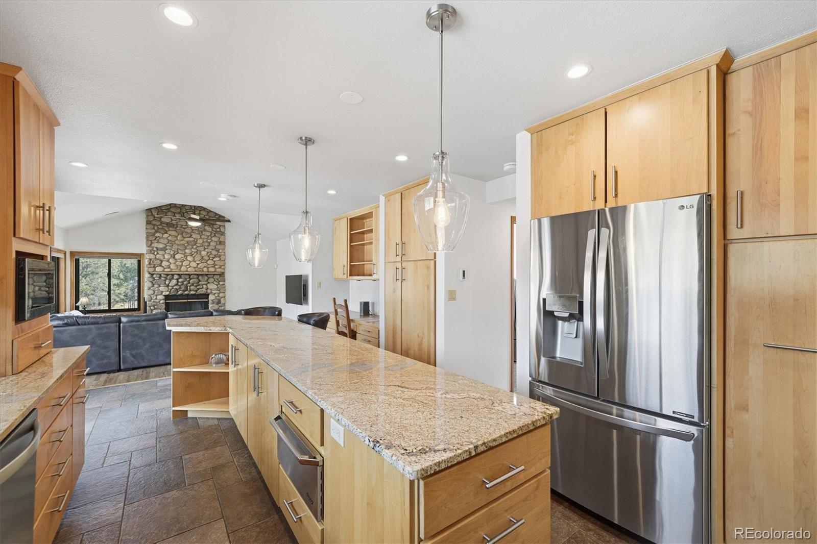 2565 Nova Road Pine, CO 80470 - Photo 6 of 50 a kitchen with stainless steel appliances granite countertop a refrigerator and a sink
