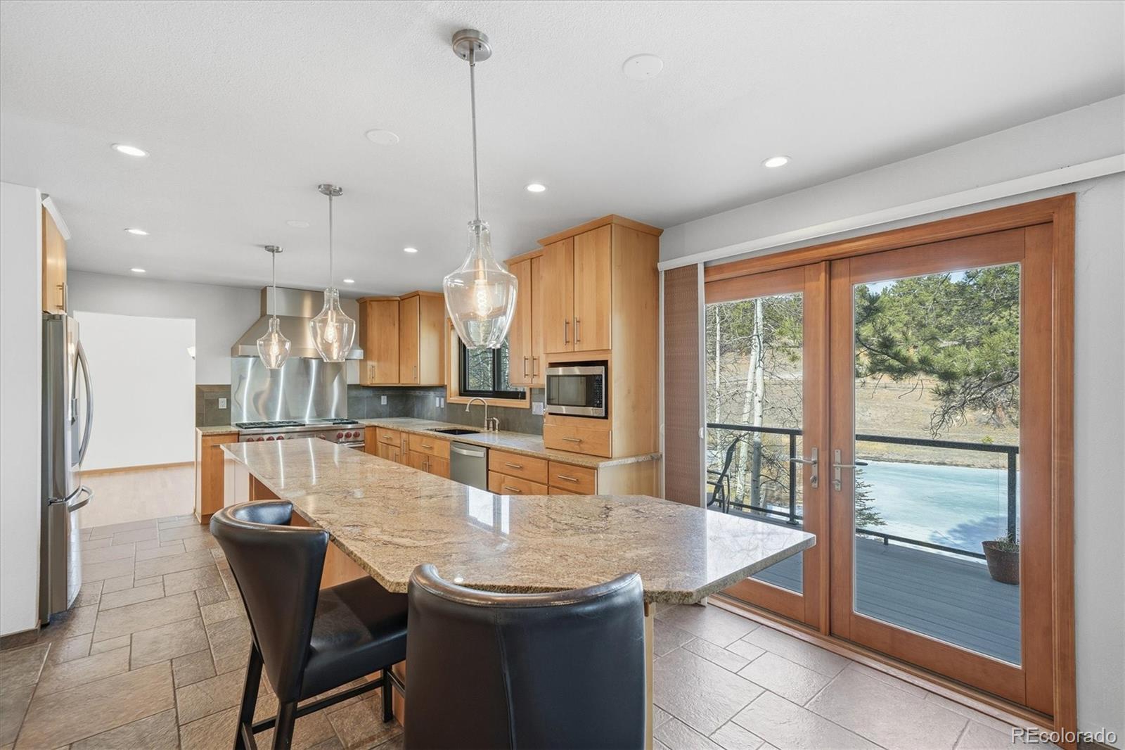 2565 Nova Road Pine, CO 80470 - Photo 10 of 50 a dining room with stainless steel appliances granite countertop furniture a large window and kitchen view