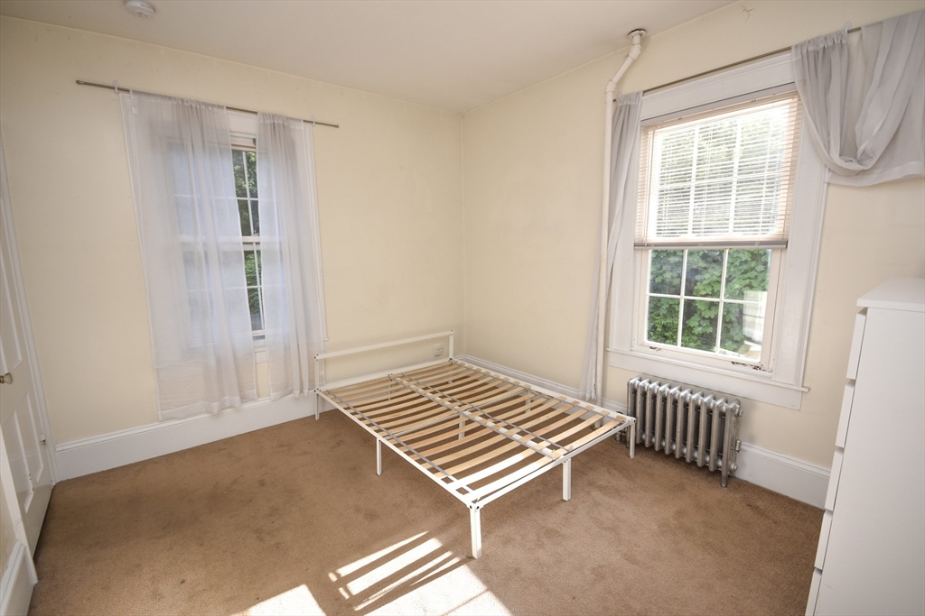 487 Main Street Amherst, MA 01002 - Photo 16 of 39 a view of a room with wooden floor and windows