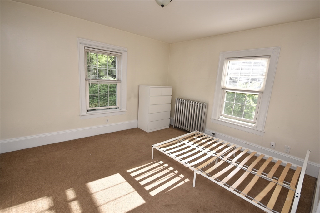 487 Main Street Amherst, MA 01002 - Photo 23 of 39 a bedroom with a bed and a window