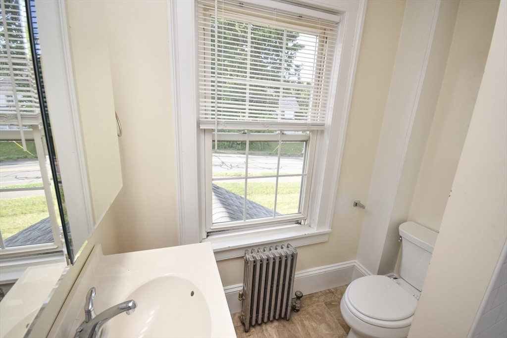 487 Main Street Amherst, MA 01002 - Photo 28 of 39 a white toilet sitting next to a window in a bathroom