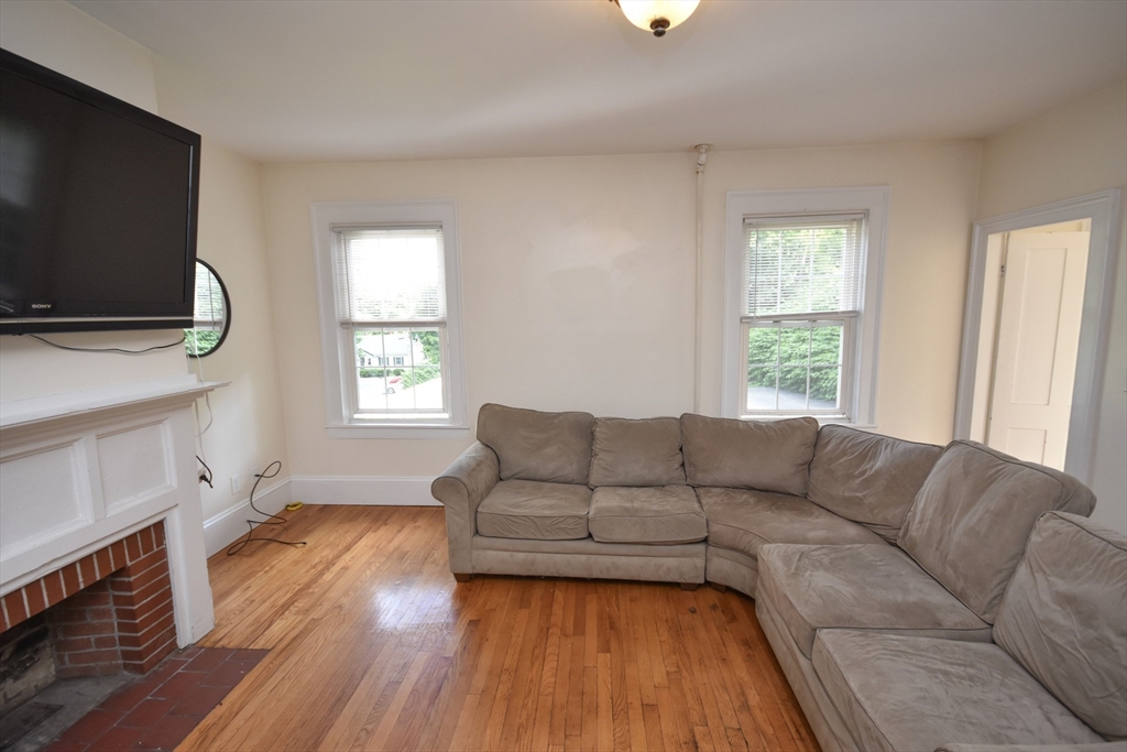 487 Main Street Amherst, MA 01002 - Photo 9 of 39 a living room with furniture and a flat screen tv