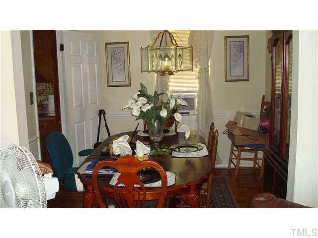 2313 Rock Quarry Road Raleigh, NC 27610 - Photo 5 of 6 a living room with furniture and wooden floor