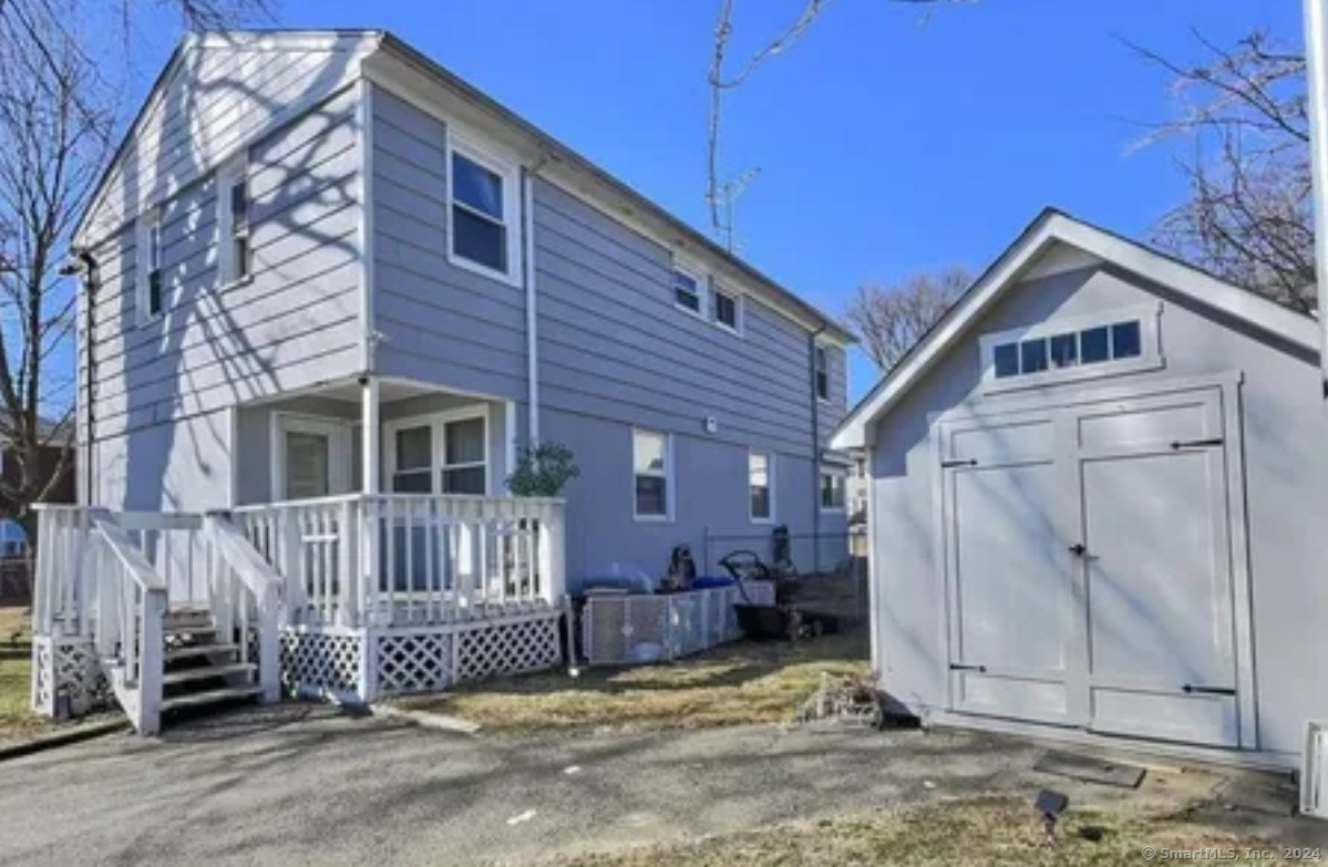 77 Marsh Way Stratford, CT 06614 - Photo 1 of 1 a view of a house with a small yard and wooden fence