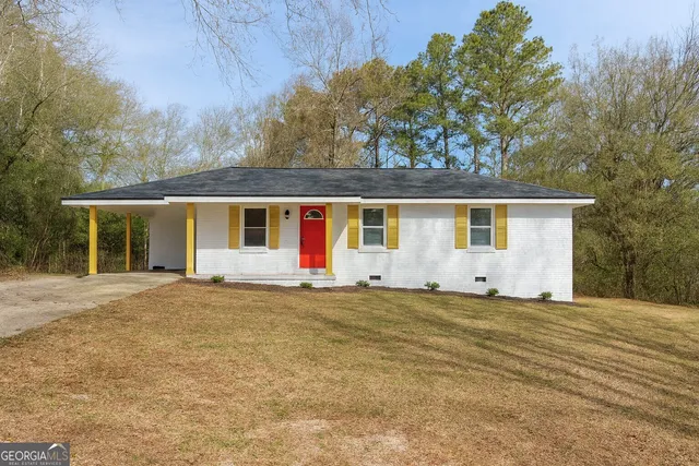 a house with trees in the background