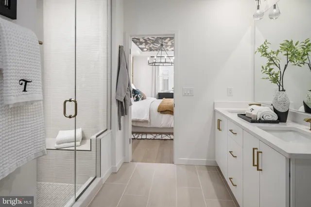 a bathroom with a granite countertop sink a toilet and shower