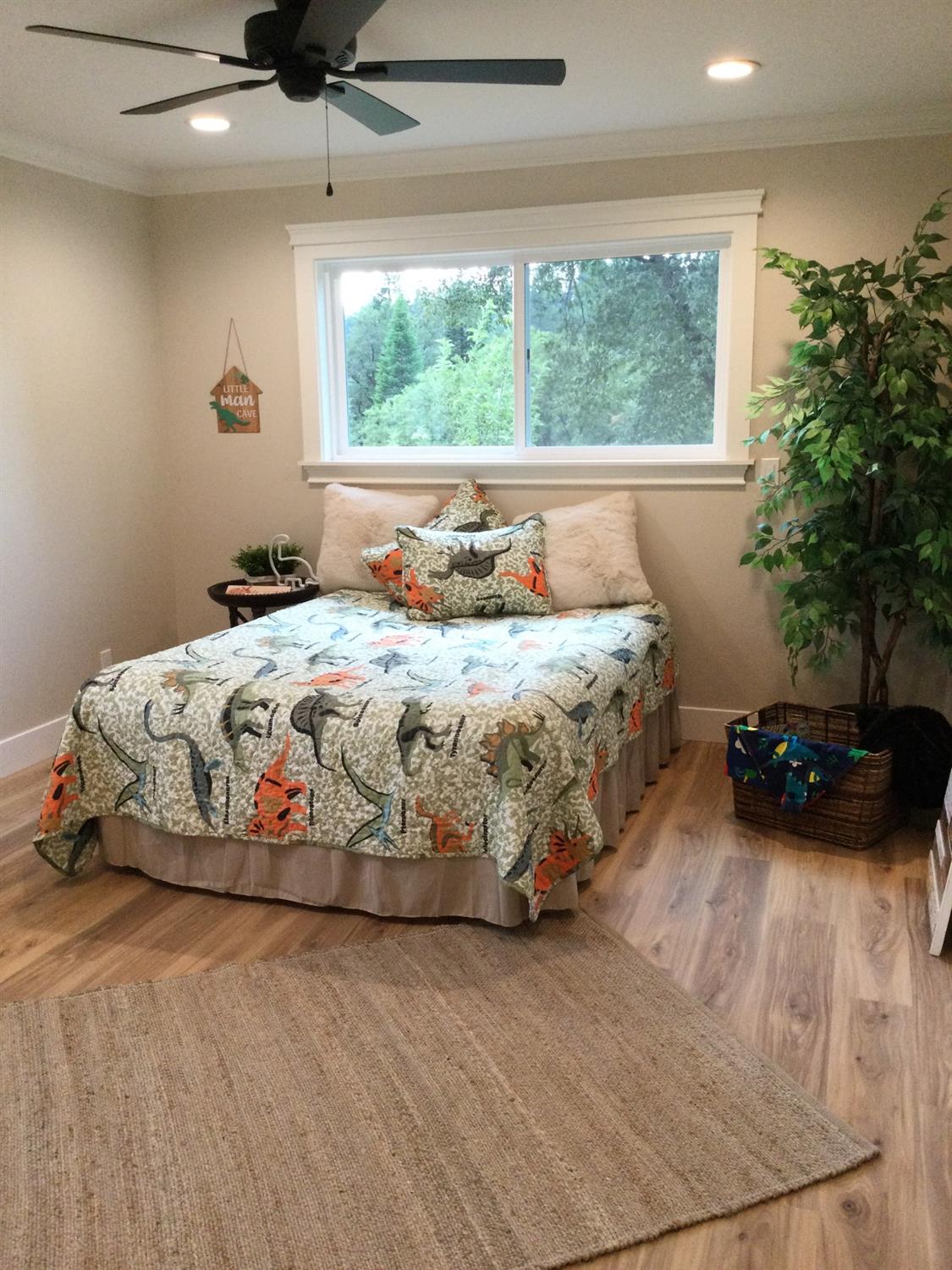 5110 Sly Park Road Pollock Pines, CA 95726 - Photo 23 of 86 a bedroom with a bed and a large window