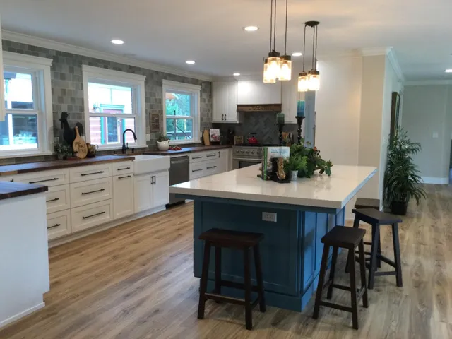 a kitchen with a table chairs sink and cabinets