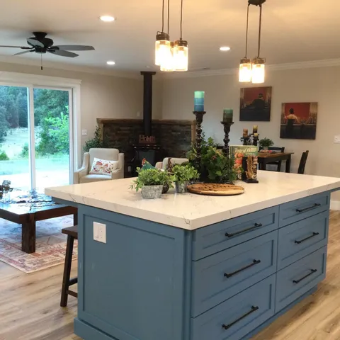 a kitchen with appliances a refrigerator and a stove top oven