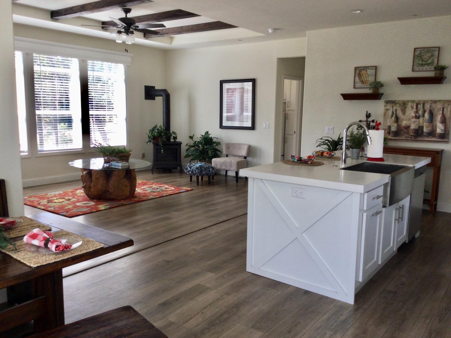 5110 Sly Park Road Pollock Pines, CA 95726 - Photo 71 of 86 a kitchen with stainless steel appliances granite countertop a stove a sink dishwasher and cabinets with wooden floor