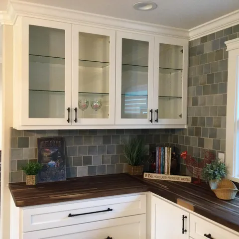 a living room with furniture a flat screen tv and a floor to ceiling window